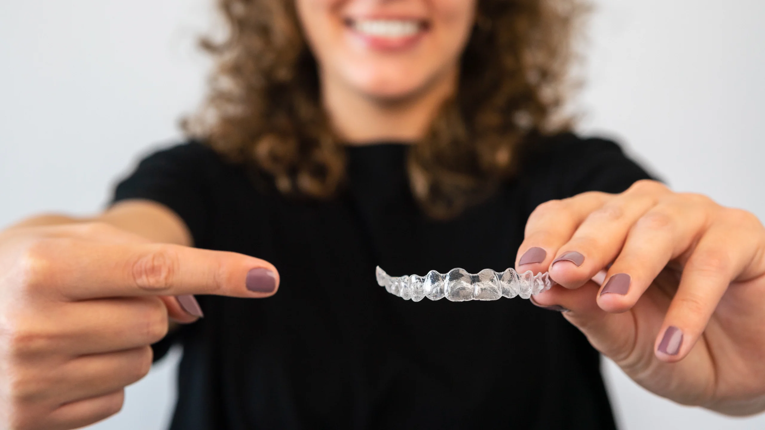 Dr Osman demonstrating Invisalign clear aligners at Face Dental, Coventry